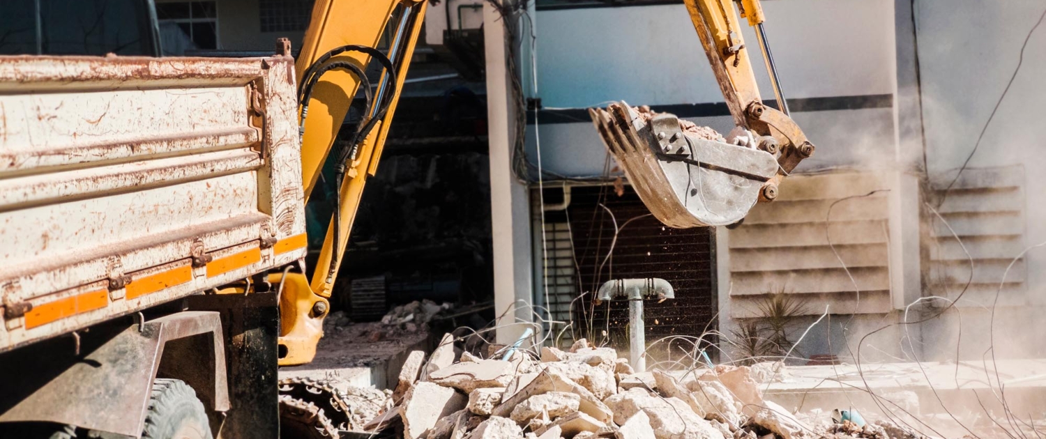 Excavator Cleaning Up Construction Site