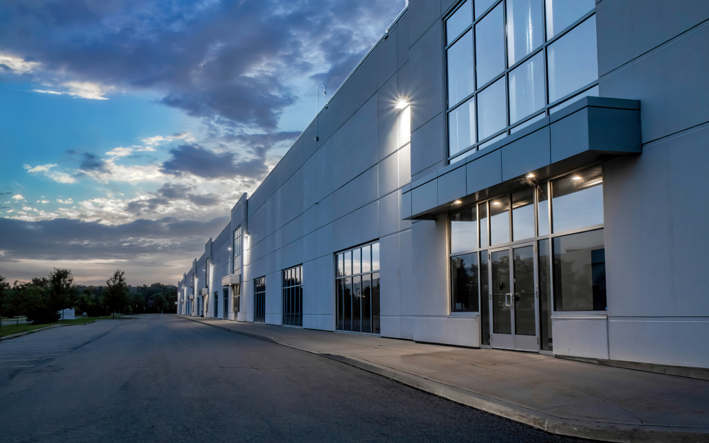 Exterior View Of A Generic Business Park Building At Dusk With Multiple High Bay Units